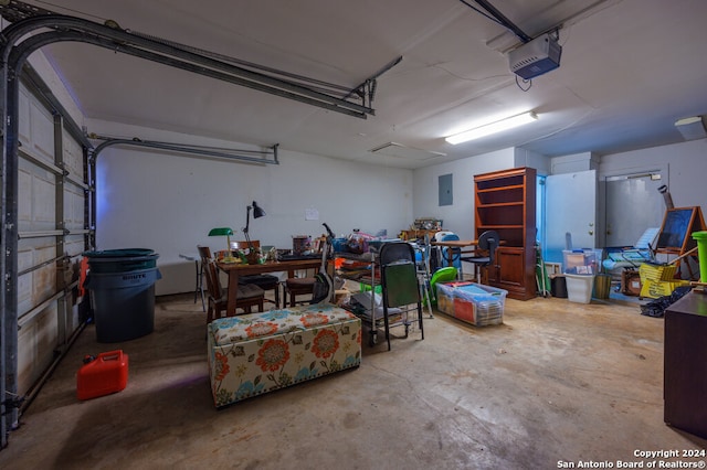 garage with a garage door opener and electric panel