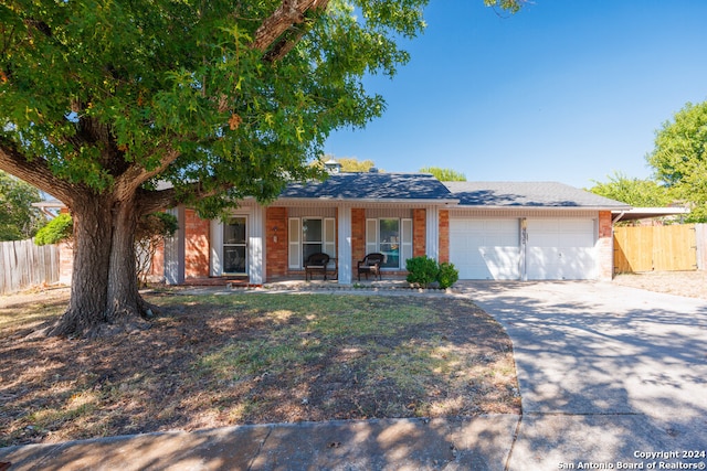 single story home featuring a porch and a garage