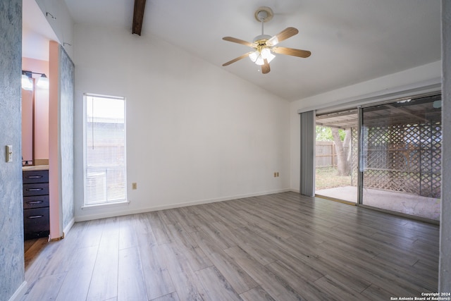 spare room with hardwood / wood-style floors, vaulted ceiling with beams, and ceiling fan