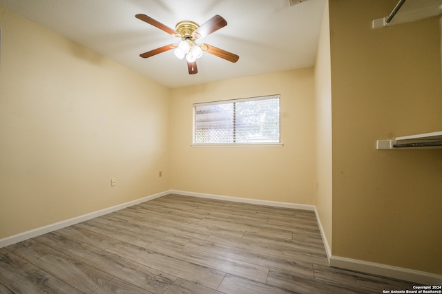 empty room with light hardwood / wood-style flooring and ceiling fan