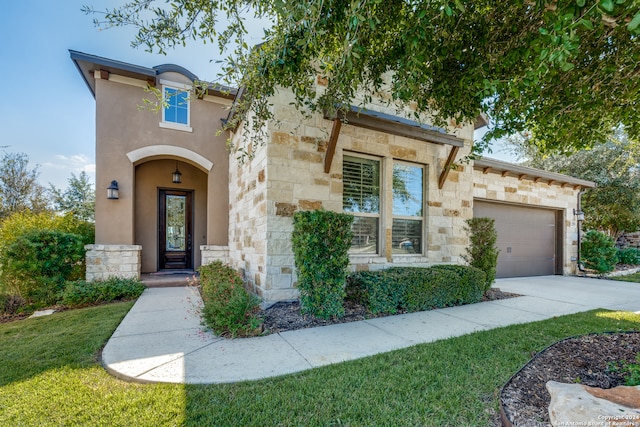 view of front of house with a front yard and a garage