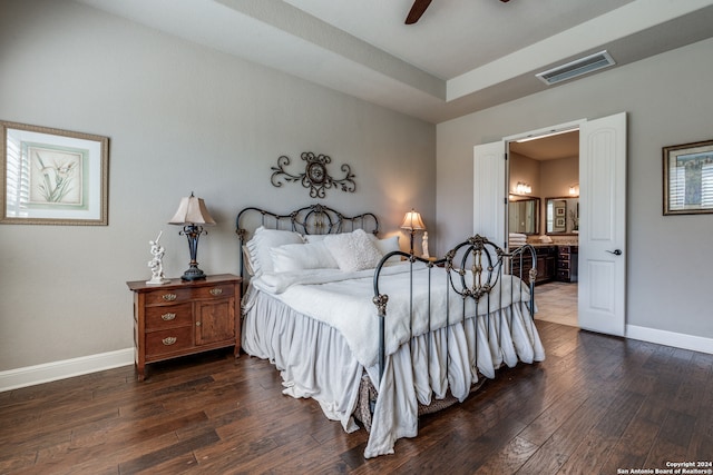 bedroom with hardwood / wood-style flooring, connected bathroom, and ceiling fan