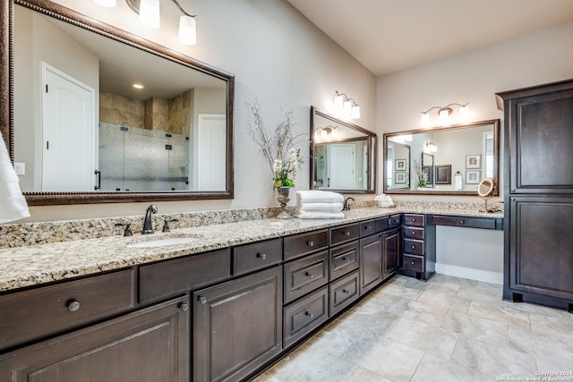 bathroom featuring vanity and an enclosed shower