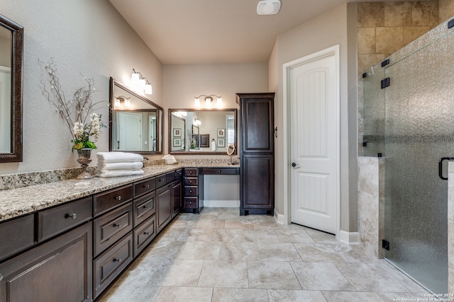 bathroom featuring vanity and a shower with door