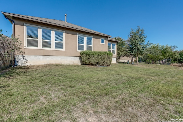 rear view of house with a yard