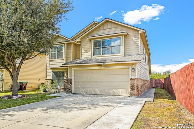 view of front facade featuring a front yard and a garage