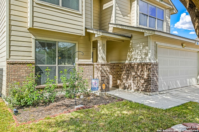 doorway to property with a garage