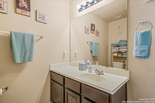 bathroom with toilet and vanity