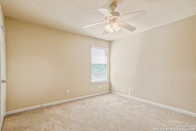 carpeted empty room with a textured ceiling and ceiling fan