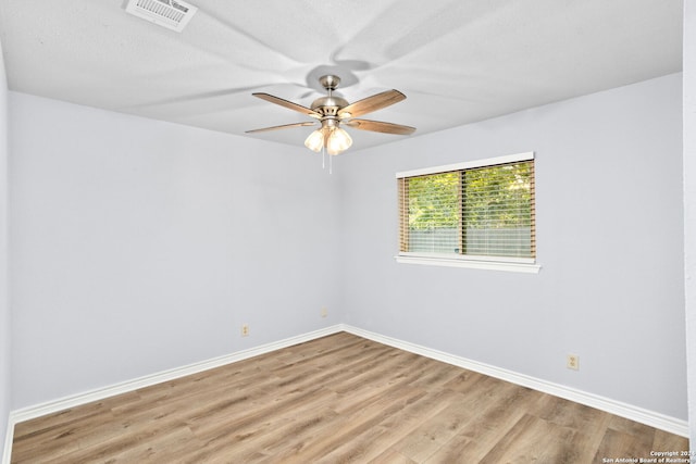 unfurnished room featuring a textured ceiling, light wood-type flooring, and ceiling fan