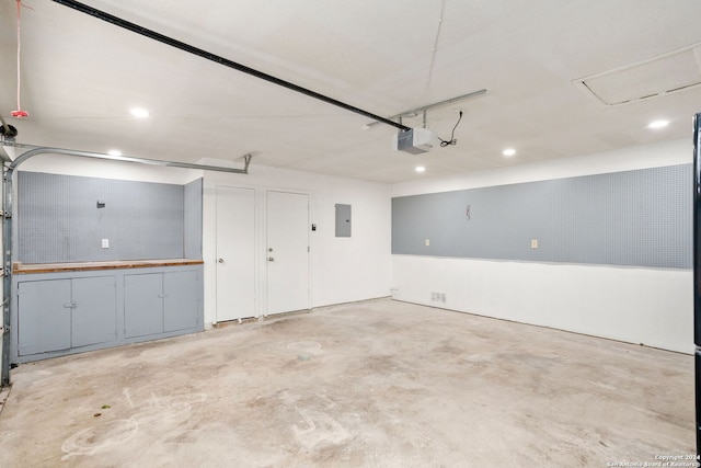 garage featuring a garage door opener and electric panel