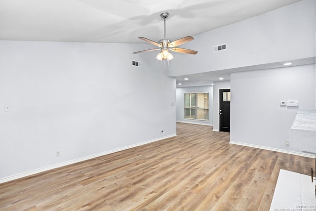 unfurnished living room with high vaulted ceiling, light wood-type flooring, and ceiling fan