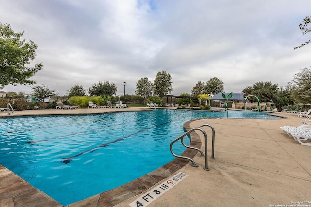 view of swimming pool with a patio area