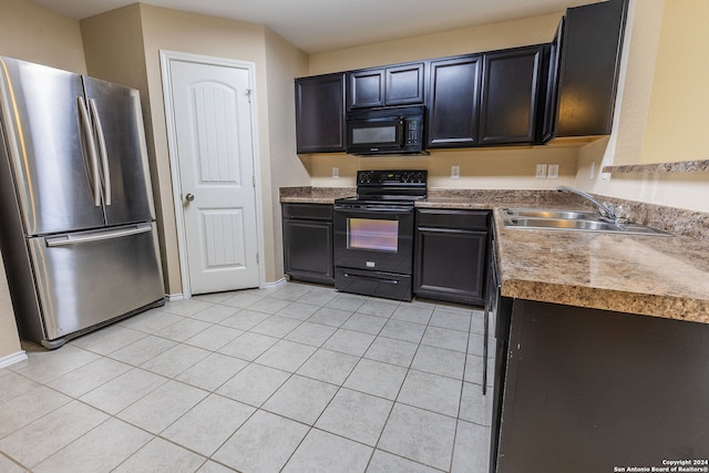 kitchen featuring black appliances, light tile patterned floors, and sink