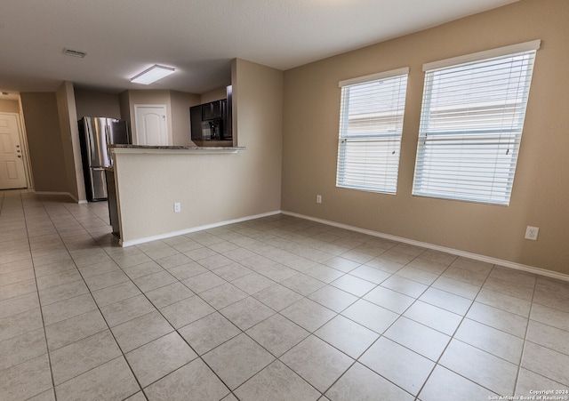 unfurnished living room featuring light tile patterned flooring