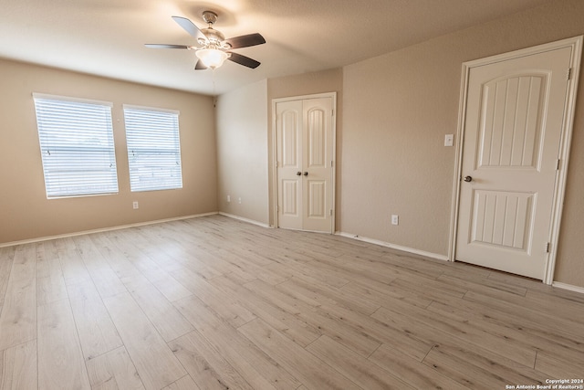 empty room featuring ceiling fan and light hardwood / wood-style floors