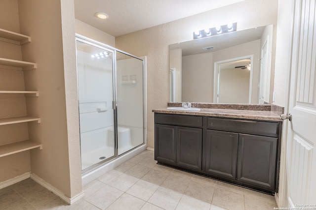 bathroom with vanity, tile patterned floors, and a shower with shower door