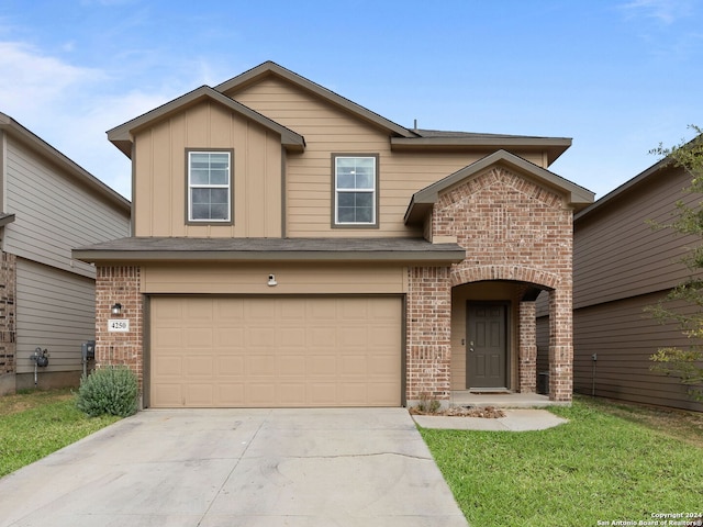 front of property featuring a front yard and a garage