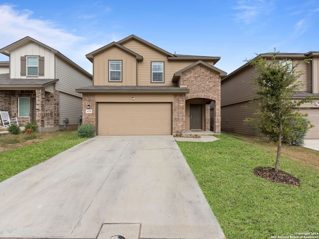 view of front of home with brick siding, a garage, board and batten siding, a front yard, and driveway