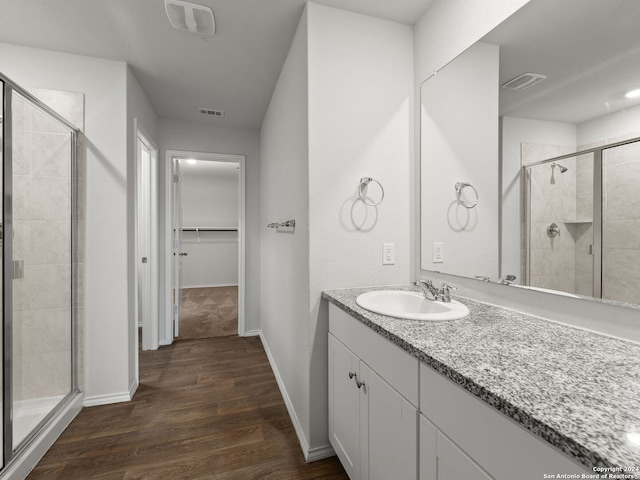 bathroom with visible vents, a shower stall, and a spacious closet