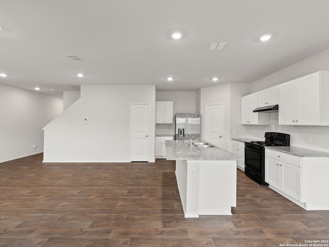 kitchen featuring a center island with sink, stainless steel fridge with ice dispenser, black gas stove, and white cabinets