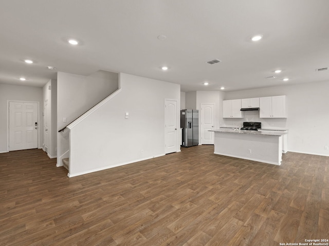 unfurnished living room with dark wood-type flooring