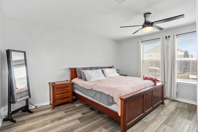 bedroom with ceiling fan and light hardwood / wood-style flooring