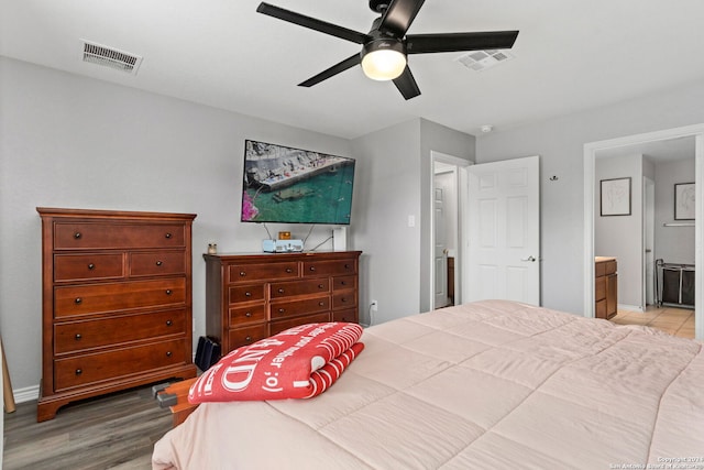 bedroom featuring light hardwood / wood-style flooring, connected bathroom, and ceiling fan