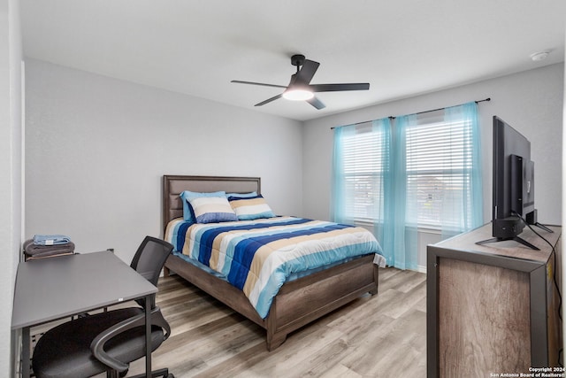 bedroom with ceiling fan and light hardwood / wood-style flooring