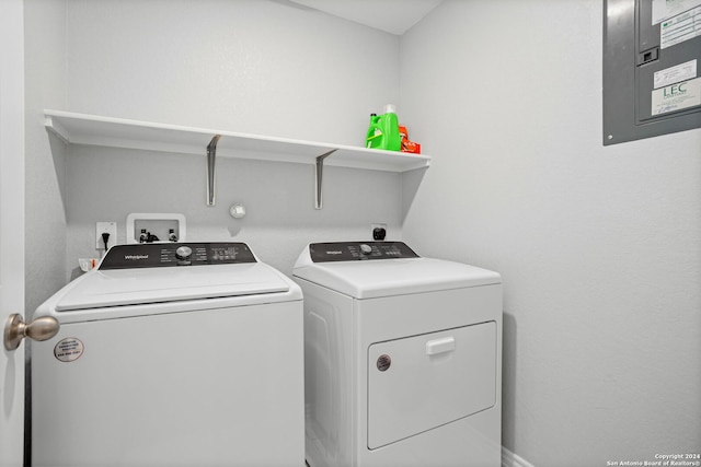 clothes washing area with electric panel and washer and clothes dryer