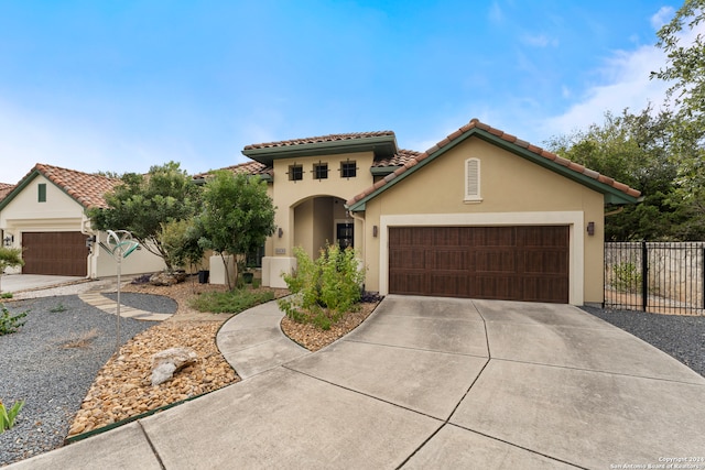 mediterranean / spanish home with a garage