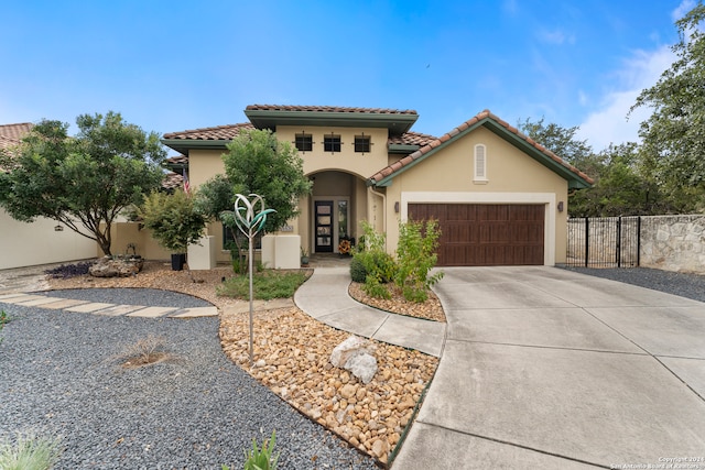 mediterranean / spanish-style home with a garage