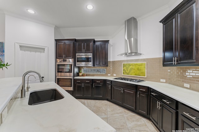 kitchen with stainless steel appliances, wall chimney exhaust hood, sink, crown molding, and backsplash