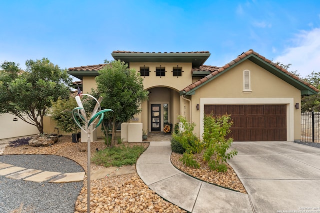 mediterranean / spanish house with a garage