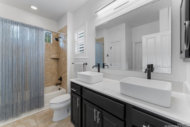 full bathroom with tile patterned flooring, vanity, toilet, and shower / bathtub combination with curtain