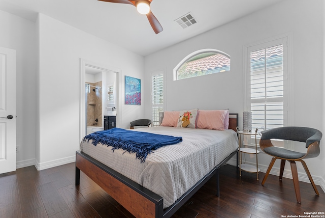 bedroom with dark wood-type flooring, ceiling fan, and connected bathroom