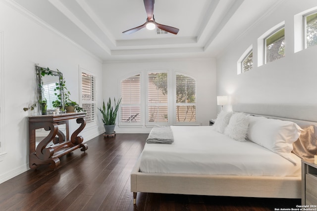 bedroom with ornamental molding, a raised ceiling, ceiling fan, and dark hardwood / wood-style floors