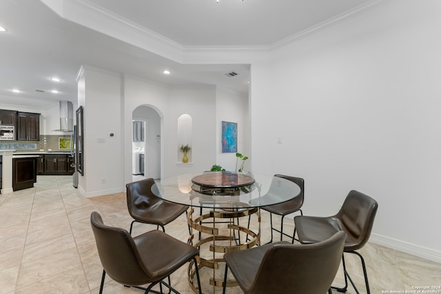 tiled dining area featuring ornamental molding