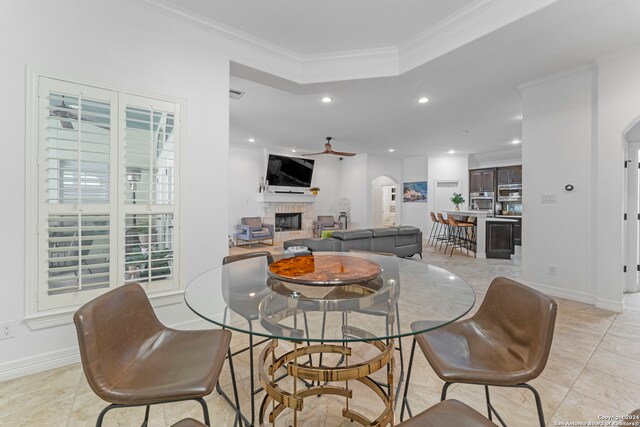 tiled dining room featuring ceiling fan and ornamental molding