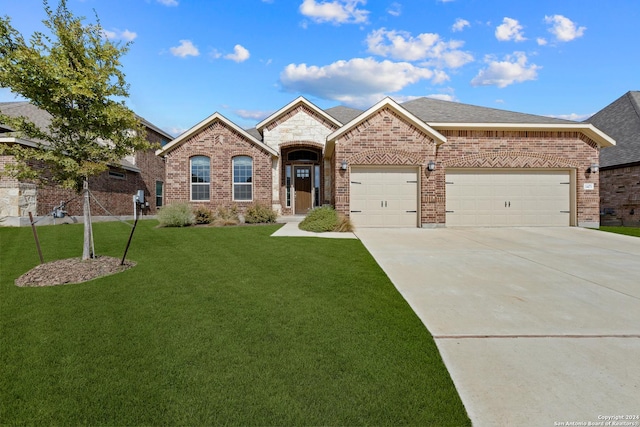 14471 Costa Leon, San Antonio, TX 78245 - french country inspired facade with brick siding, driveway, a front lawn, and an attached garage