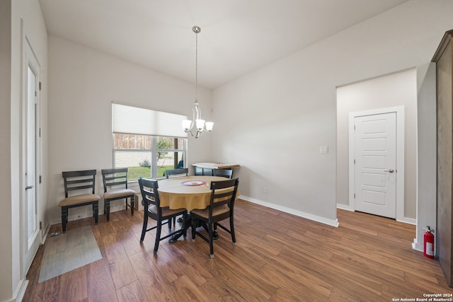 dining room with a notable chandelier and dark hardwood / wood-style floors