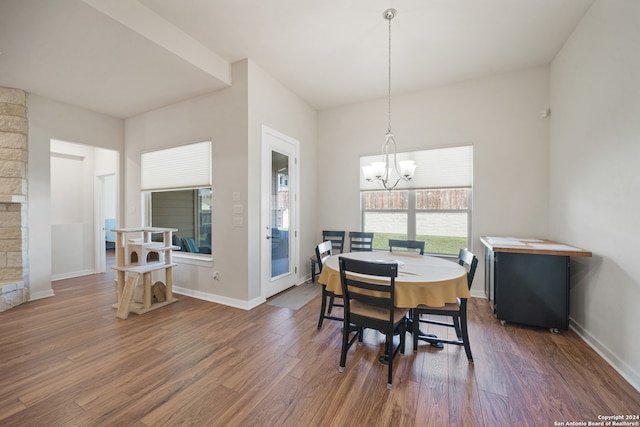 dining room featuring an inviting chandelier and dark wood-type flooring