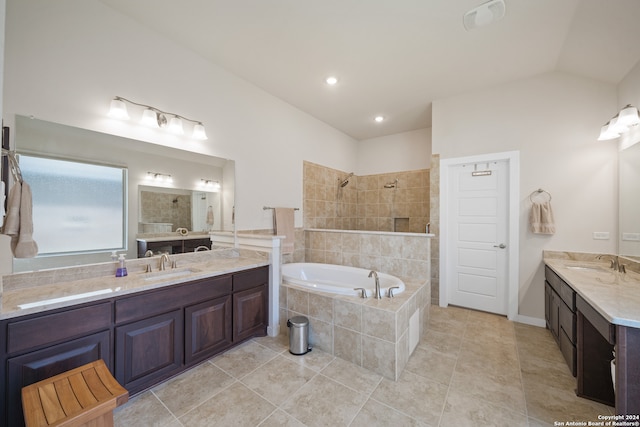 bathroom with vanity, vaulted ceiling, plus walk in shower, and tile patterned flooring