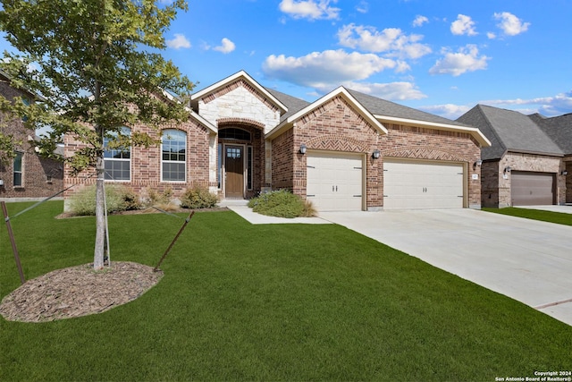 14471 Costa Leon, San Antonio, TX 78245 - french country home with brick siding, an attached garage, concrete driveway, and a front yard