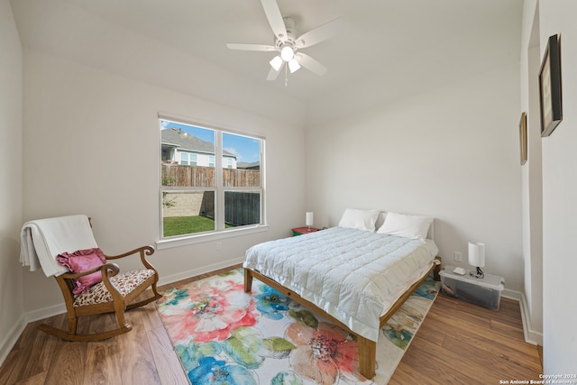 bedroom with ceiling fan and hardwood / wood-style flooring