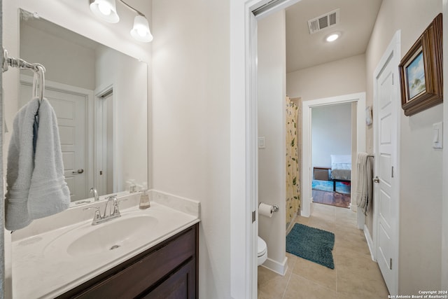 bathroom featuring vanity, toilet, and tile patterned flooring