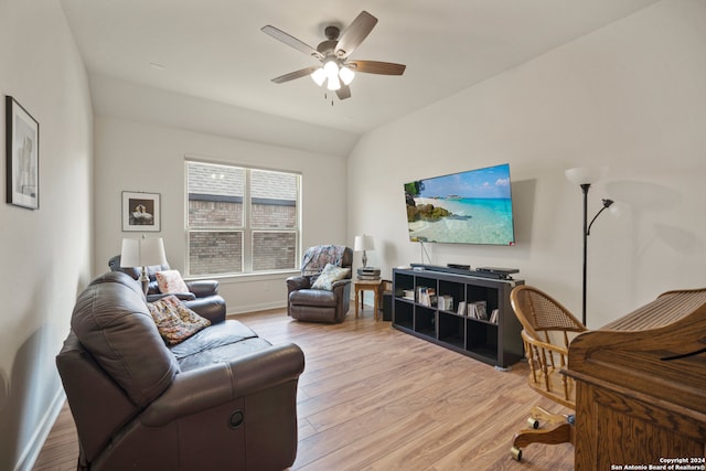 living room with vaulted ceiling, light hardwood / wood-style flooring, and ceiling fan