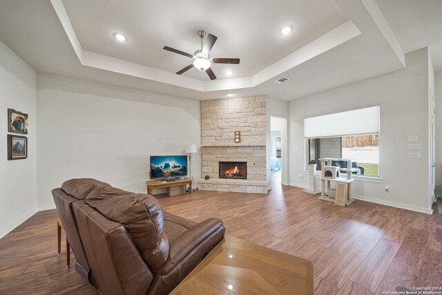 14471 Costa Leon, San Antonio, TX 78245 - living area featuring a tray ceiling, a ceiling fan, wood finished floors, a fireplace, and recessed lighting