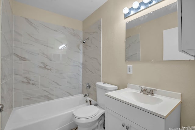 full bathroom featuring tiled shower / bath, vanity, and toilet