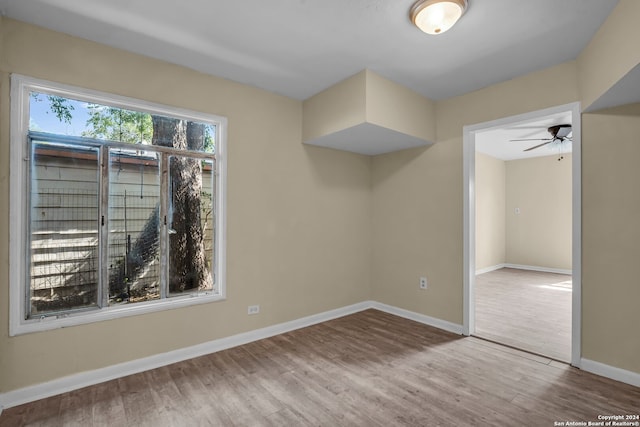 spare room featuring hardwood / wood-style floors and ceiling fan